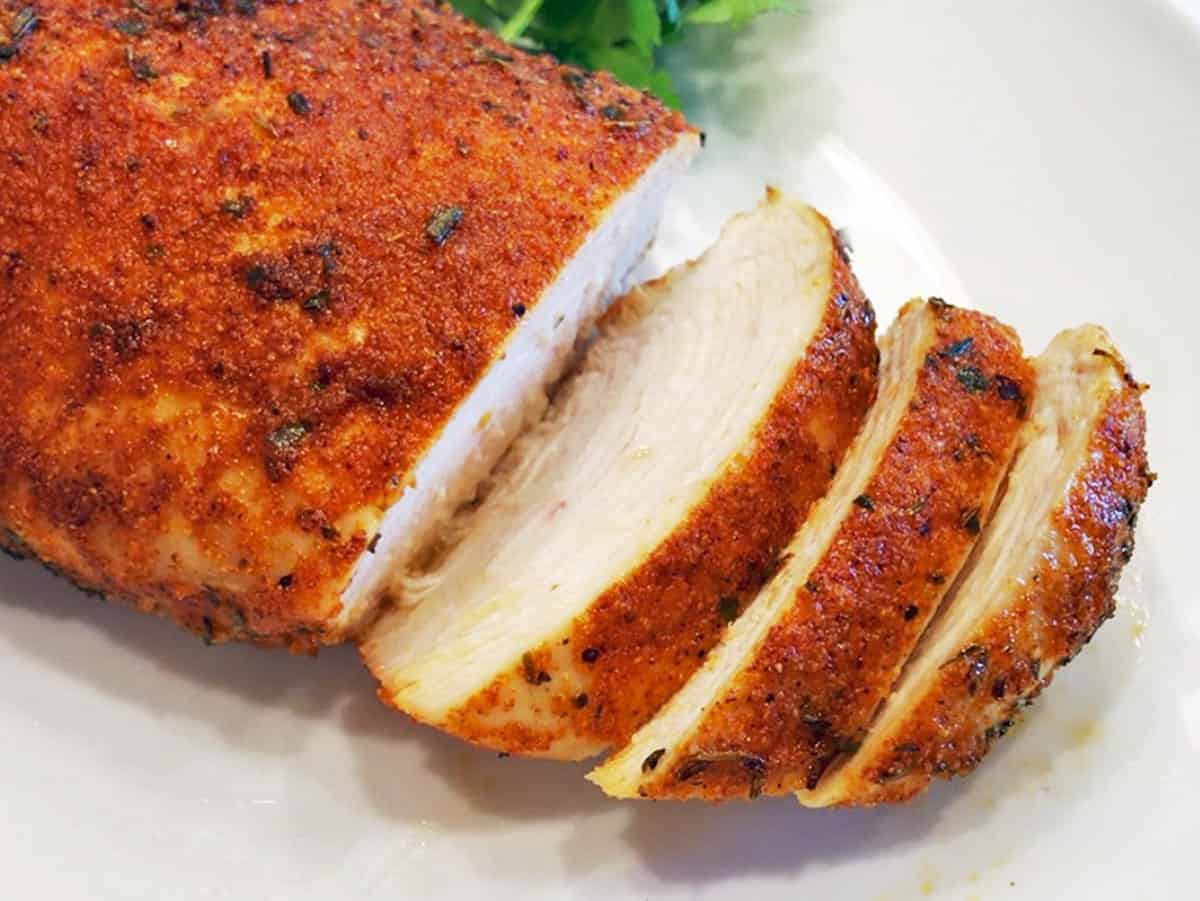 Sliced Cajun chicken on a cutting board.