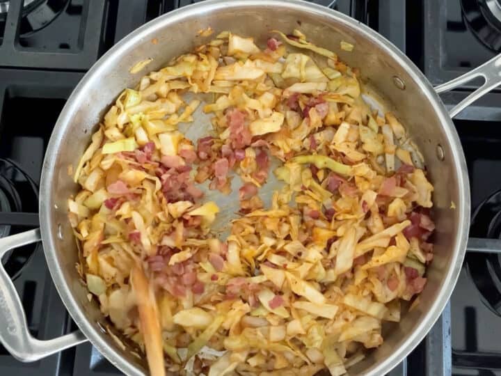 Adding the cooked bacon to the skillet.