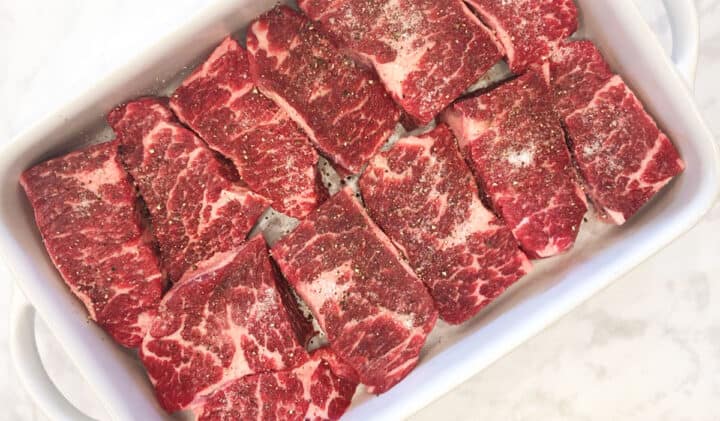 Boneless short ribs seasoned with salt and pepper.