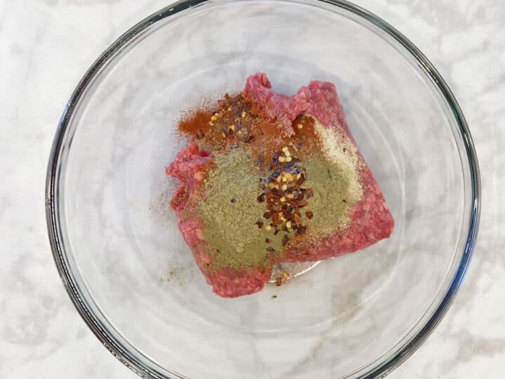 Beef sausage ingredients in a bowl.