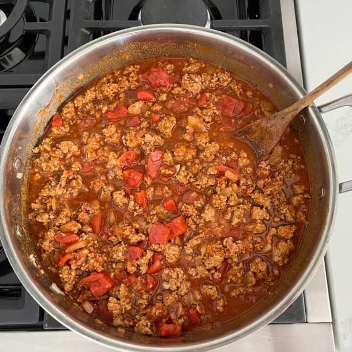 Adding liquids to the pot.