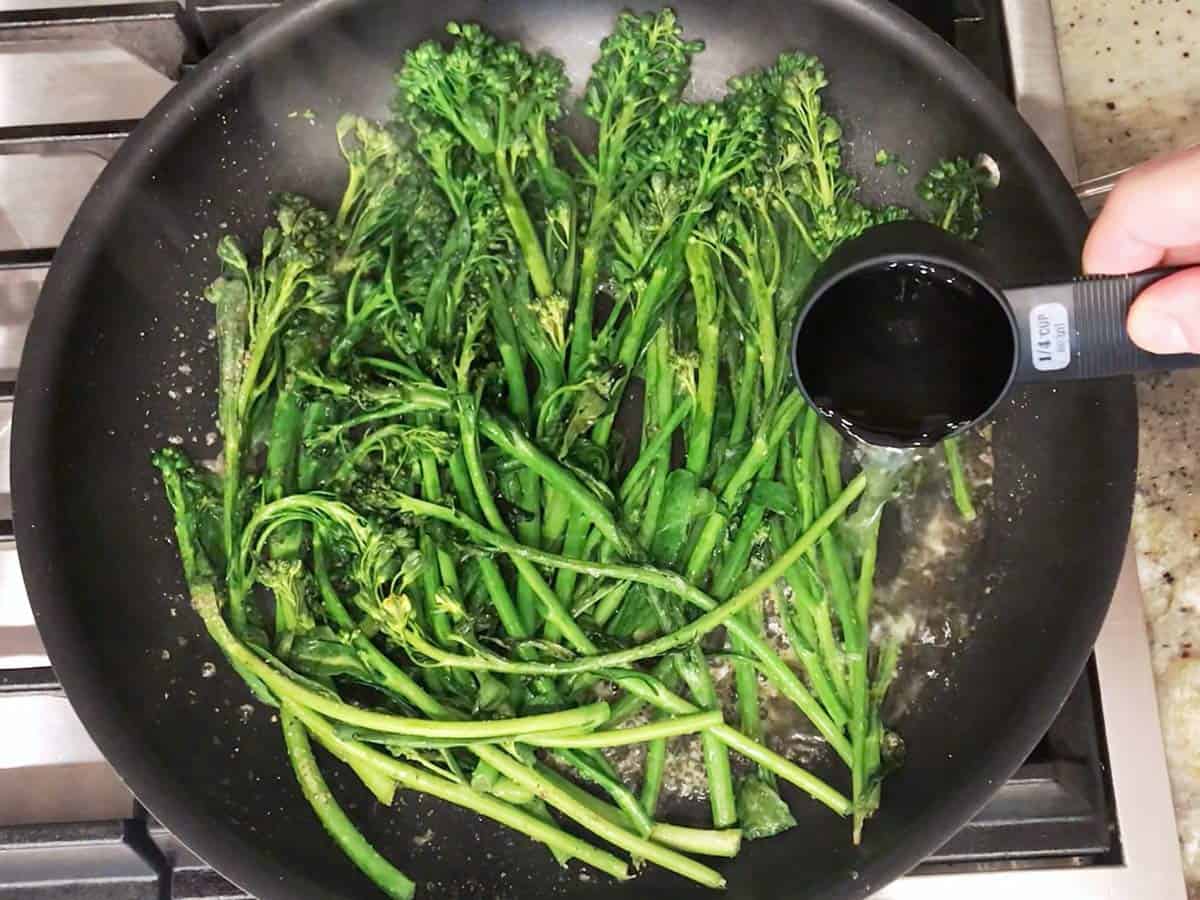 Adding water to the skillet.