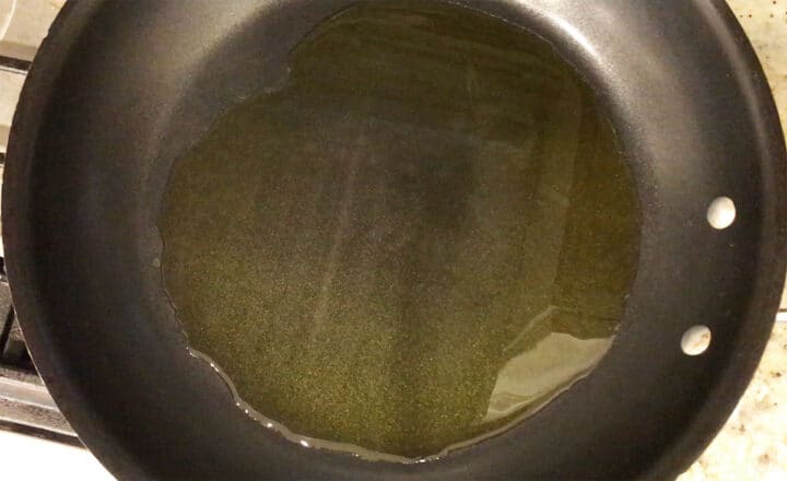 Heating the olive oil in the skillet.