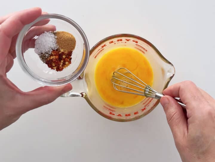 Mixing eggs and spices.