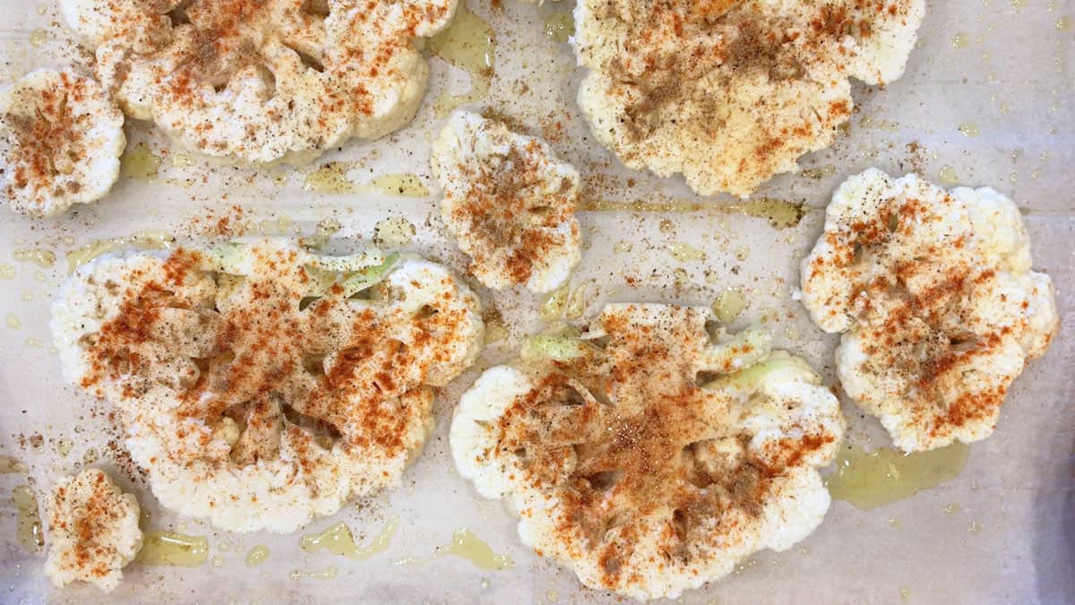 The cauliflower slices were coated in oil and seasonings.