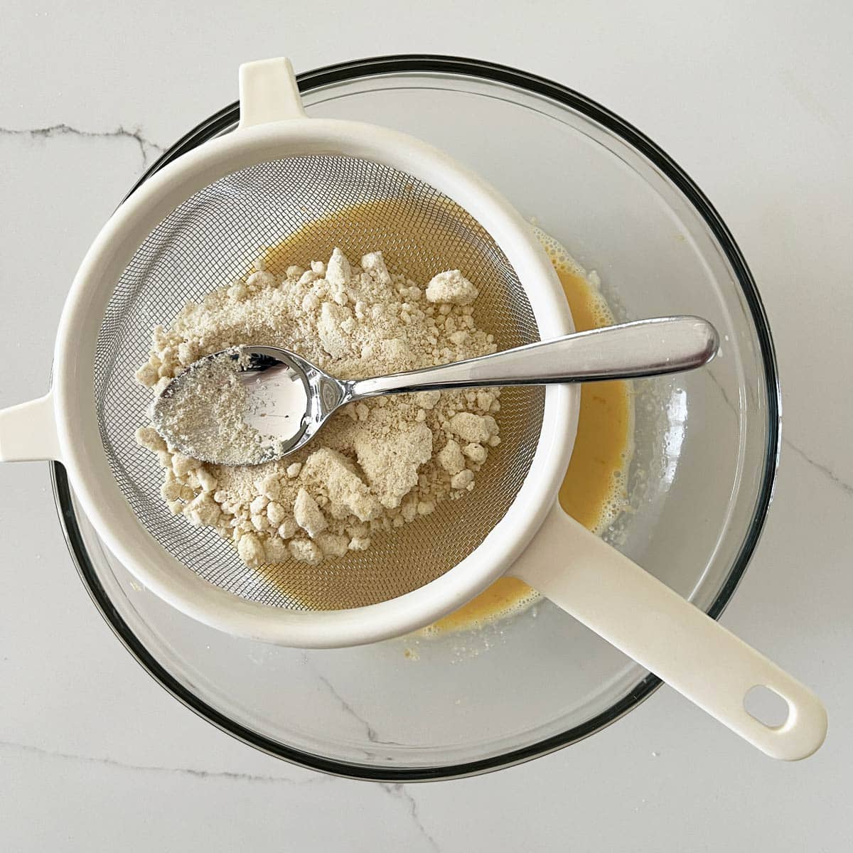 Sifting the almond flour.