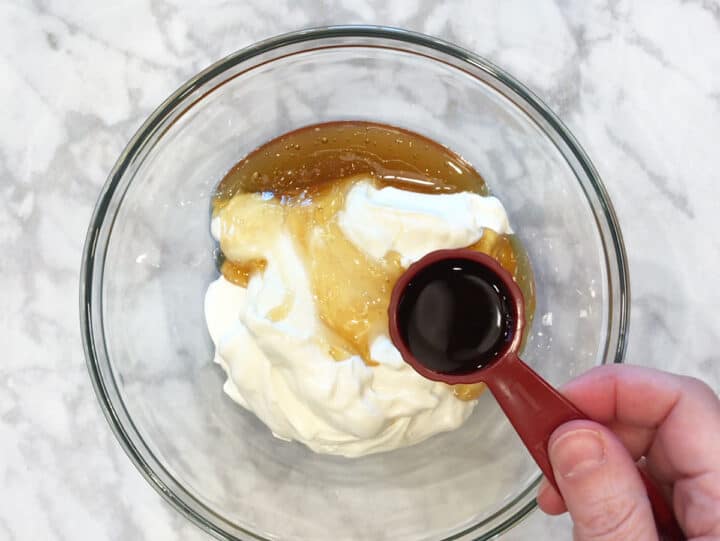 Adding frozen yogurt ingredients in a bowl.