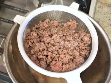 Draining the ground beef.