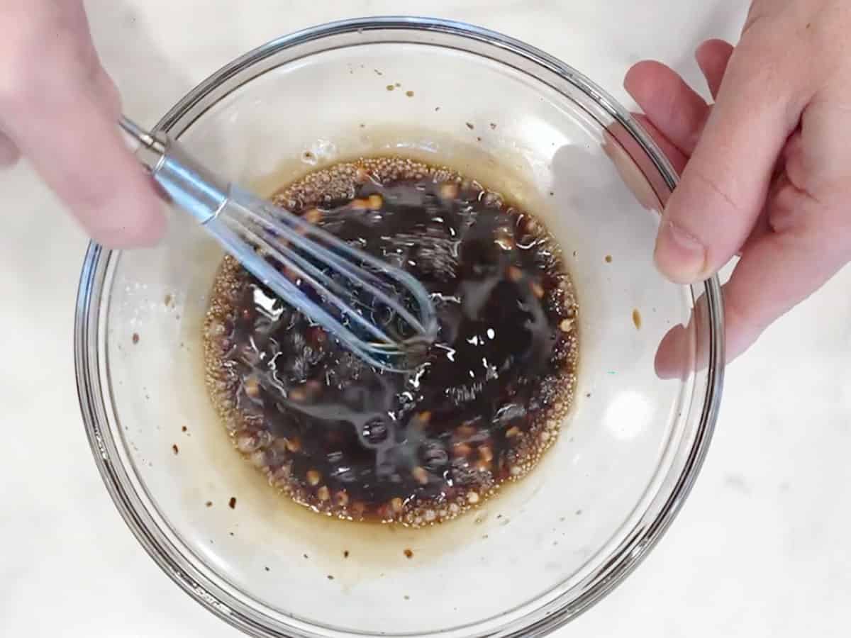 Mixing the sauce in a bowl.