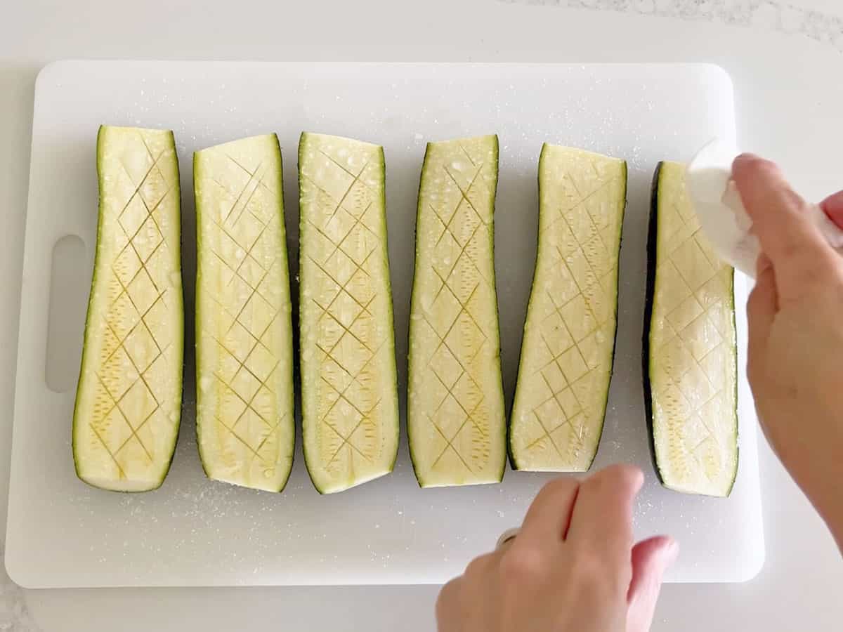 Wiping the water off the zucchini.