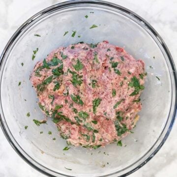 Lamb meatballs ingredients were mixed in a bowl.