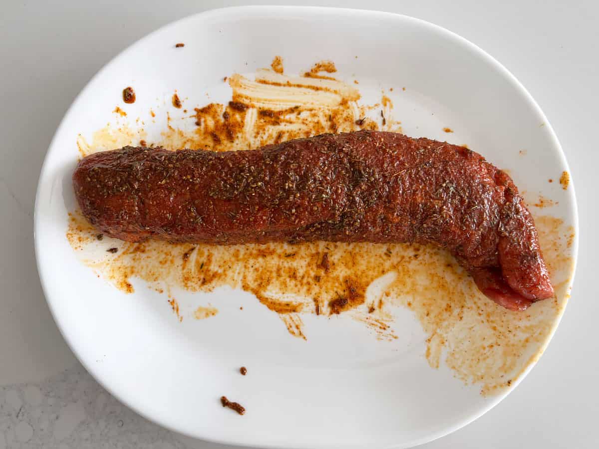 Pork tenderloin is coated in a seasoning rub.