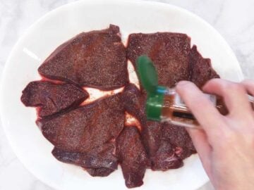 Seasoning the livers.