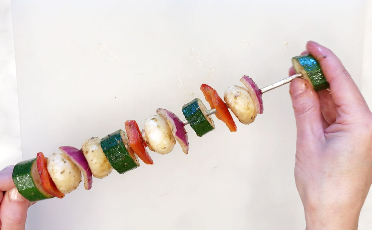 Threading the veggies on skewers.