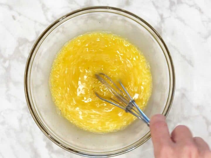 Whisking the eggs until fluffy.