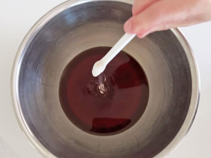 Adding baking soda to the tea.