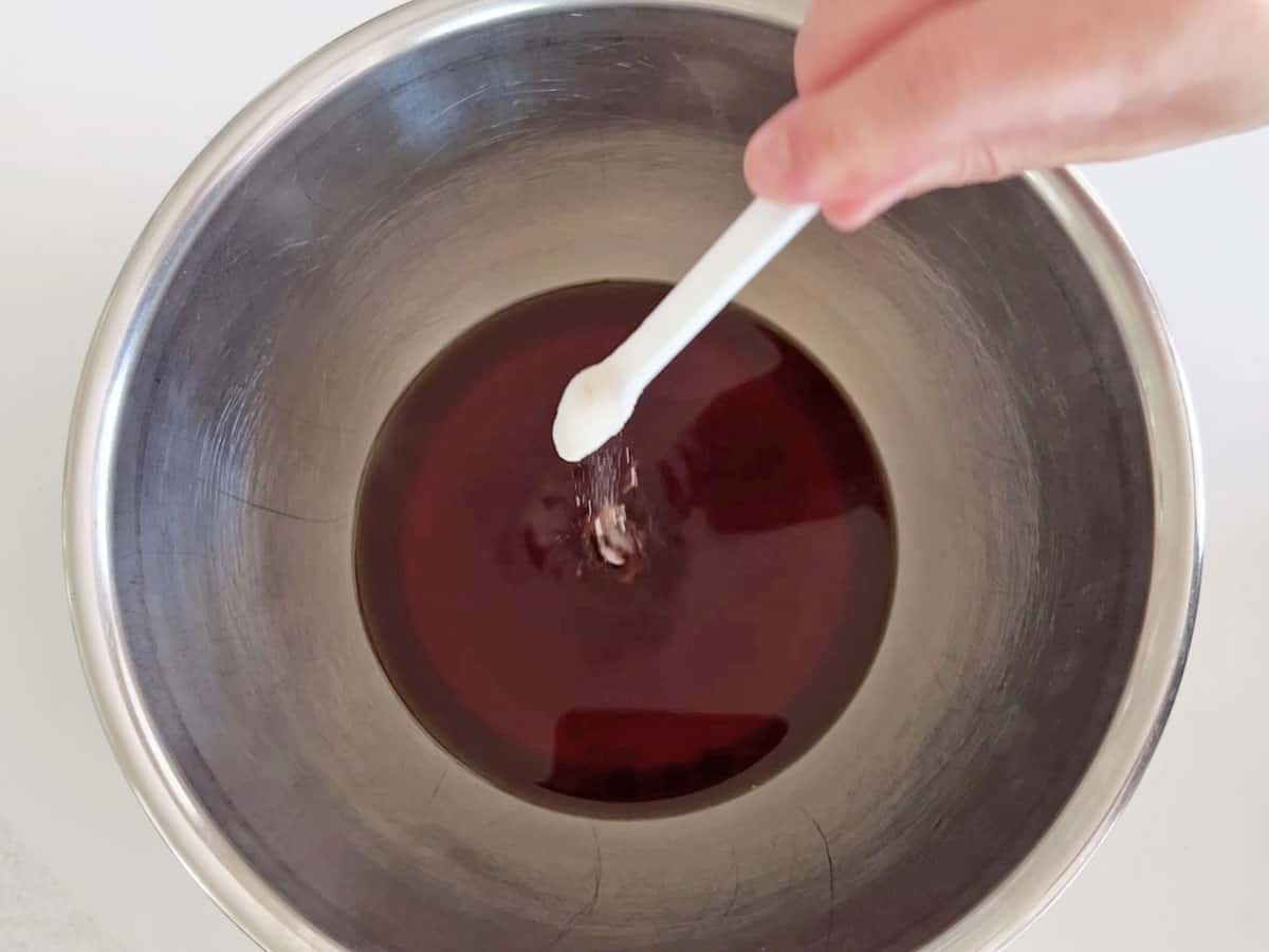 Adding baking soda to the tea.