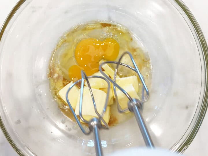 Mixing butter, stevia, vanilla, and eggs.