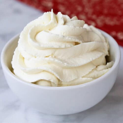 Sugar-free keto whipped cream is served in a white bowl.