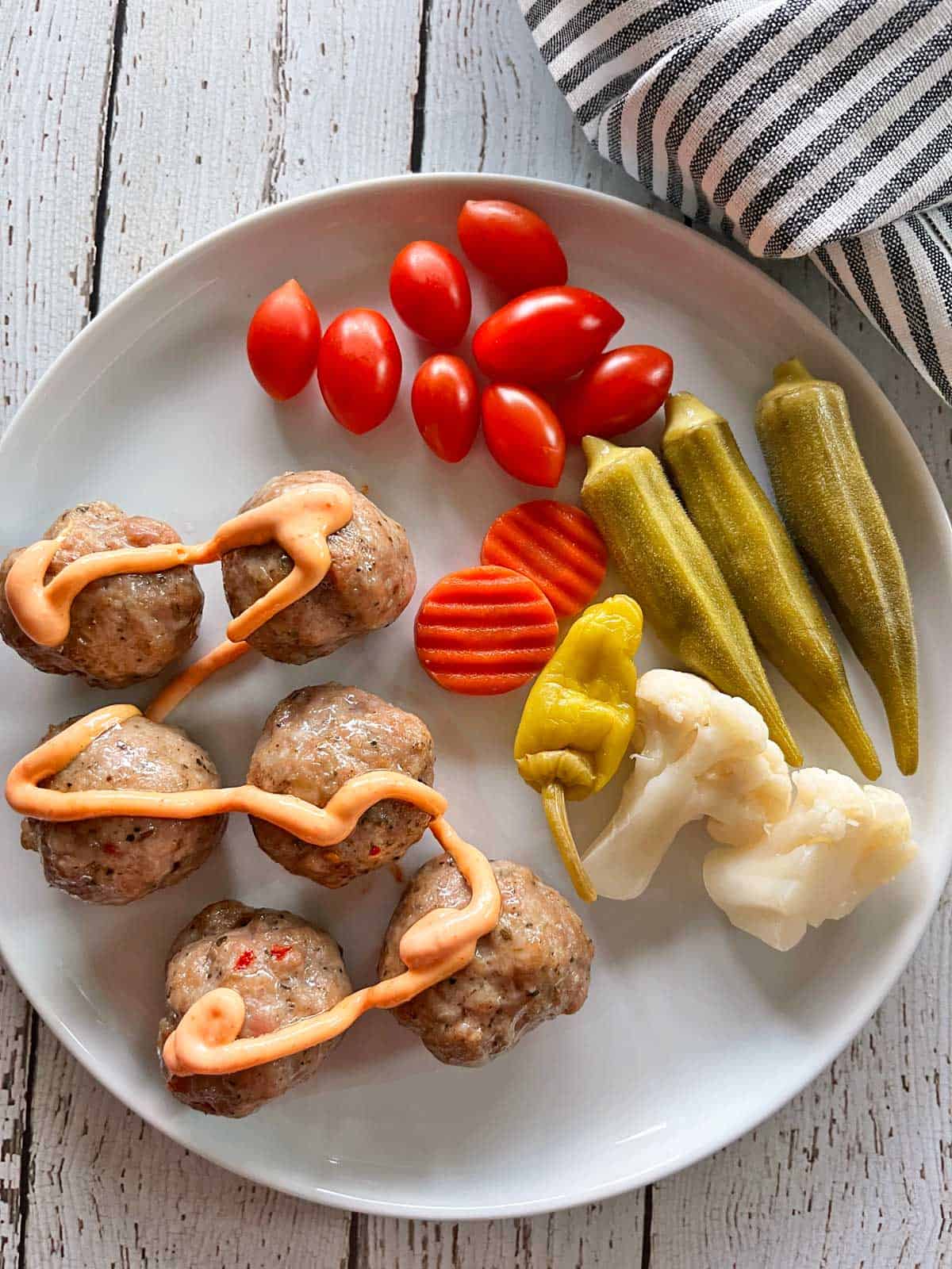 The leftovers are served with veggies and pickles.