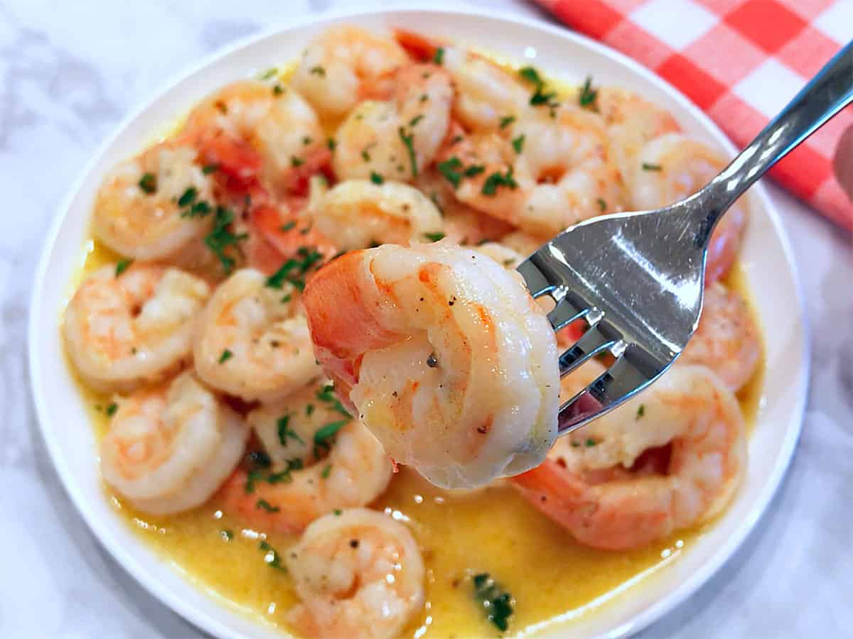 Shrimp scampi is served with a fork.