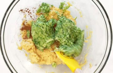 Adding almond flour and drained zucchini to the batter.