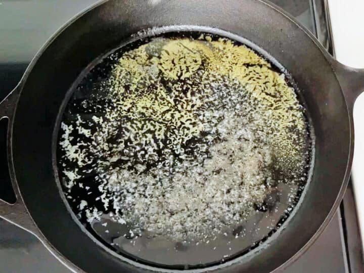 Heating butter in a cast iron skillet.