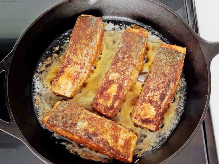 Cooking the salmon on the second side.