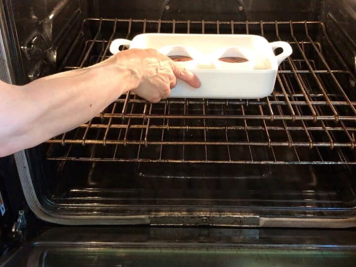 Placing the custard in the oven.