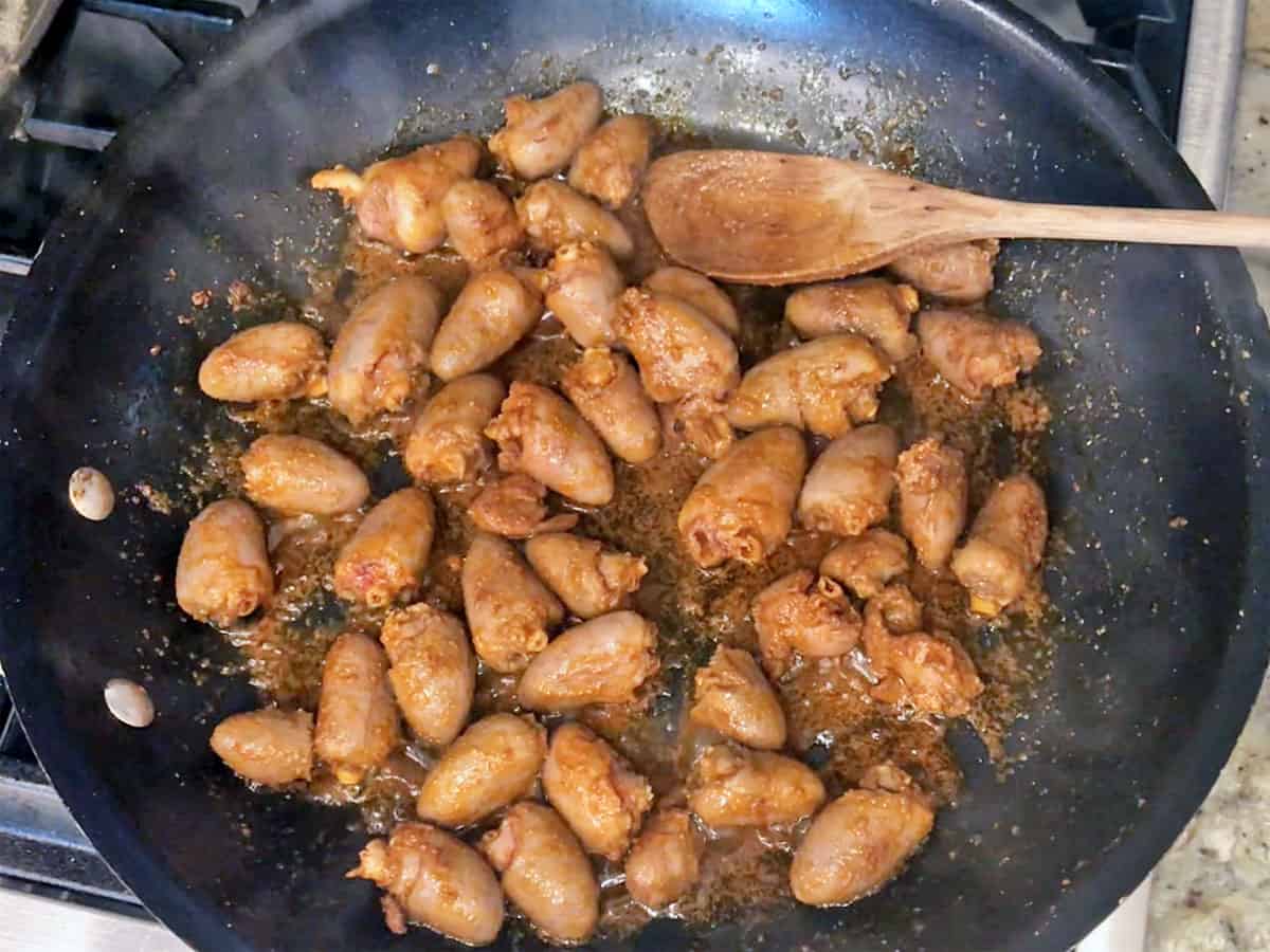 Cooking the hearts in a skillet.
