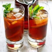 Iced tea is garnished with mint leaves.