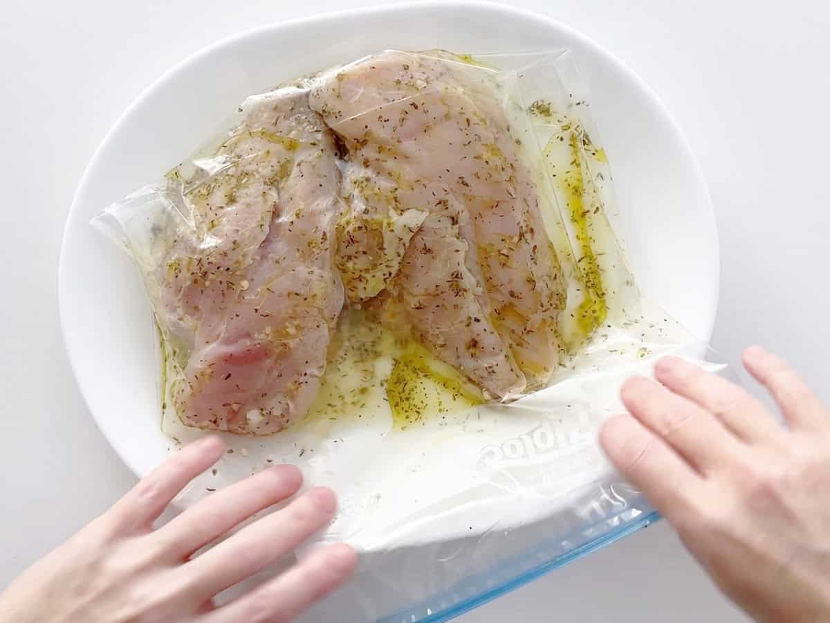 Marinating the chicken.