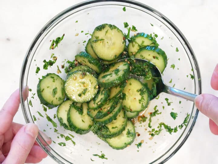 Mixing the salad in a bowl.