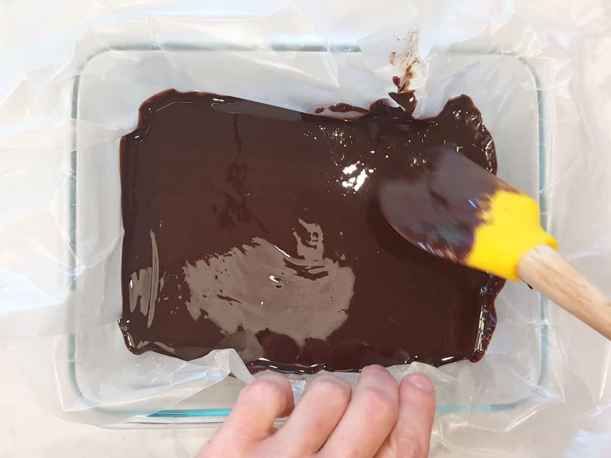 Transferring the mixture to the lined pan.