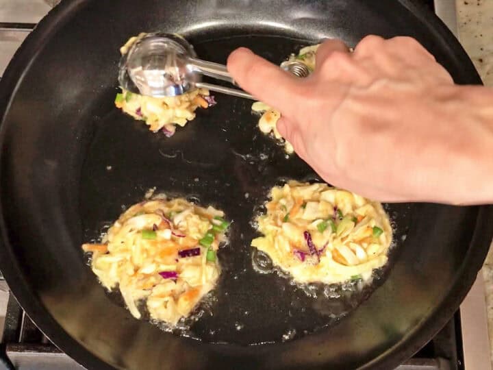 Adding mounds of the mixture to the skillet.