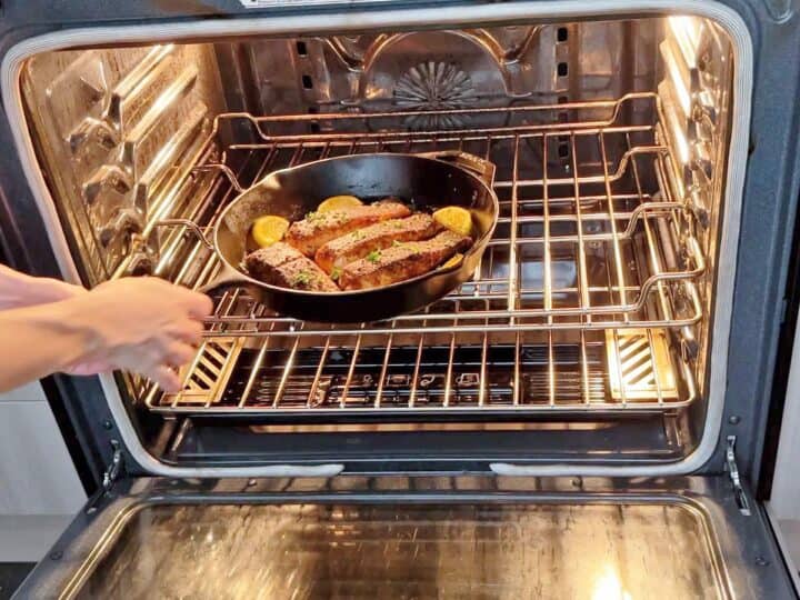 Placing the salmon in the oven.