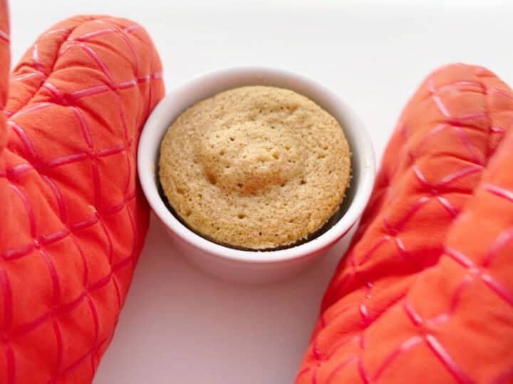 Removing the cake from the microwave.