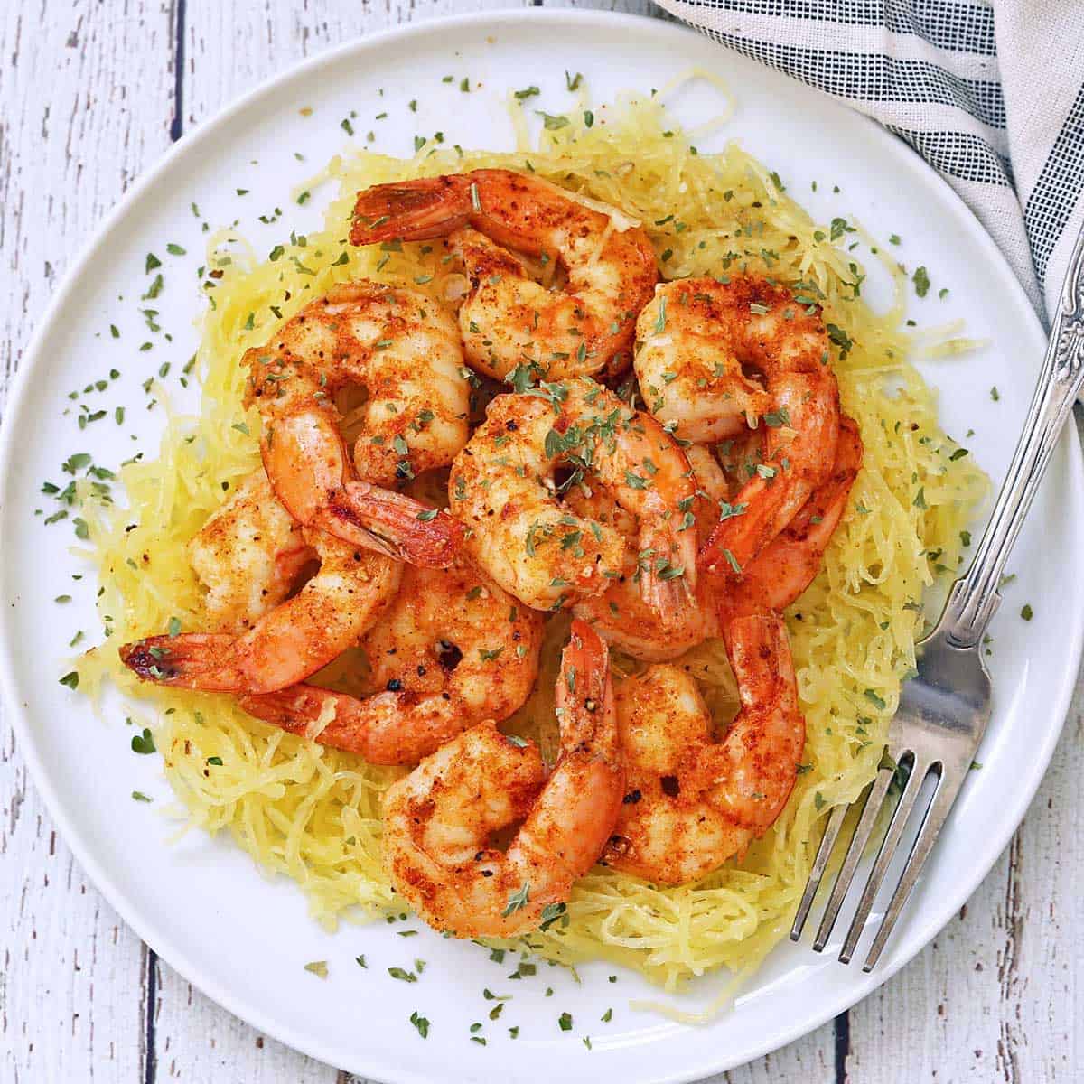 Sautéed shrimp are served on top of spaghetti squash.
