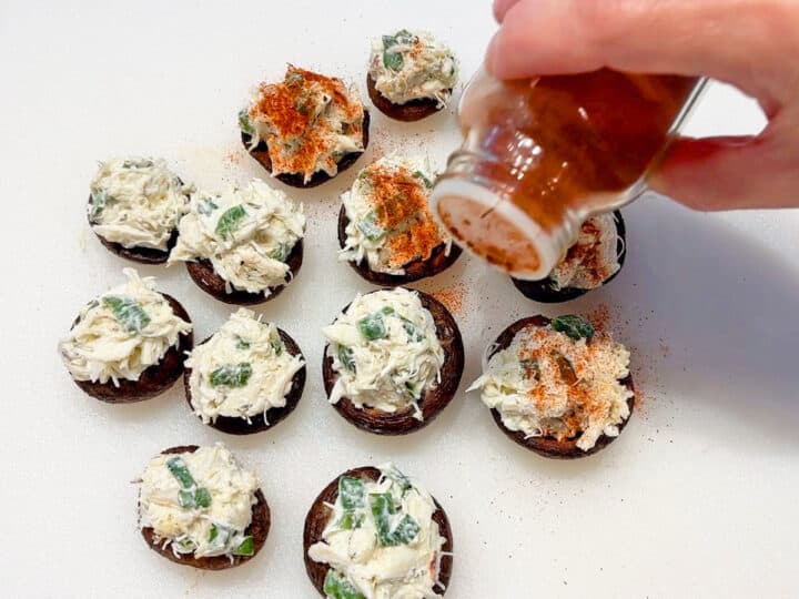 Sprinkling the mushrooms with paprika.