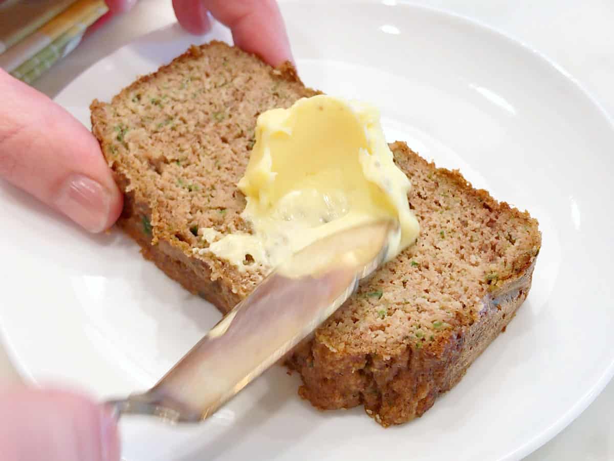 Spreading the bread with butter.