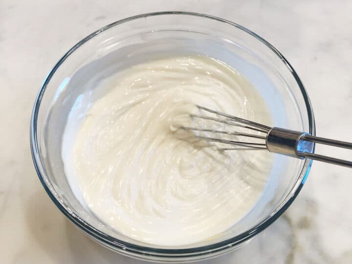 Whipping the frosting.