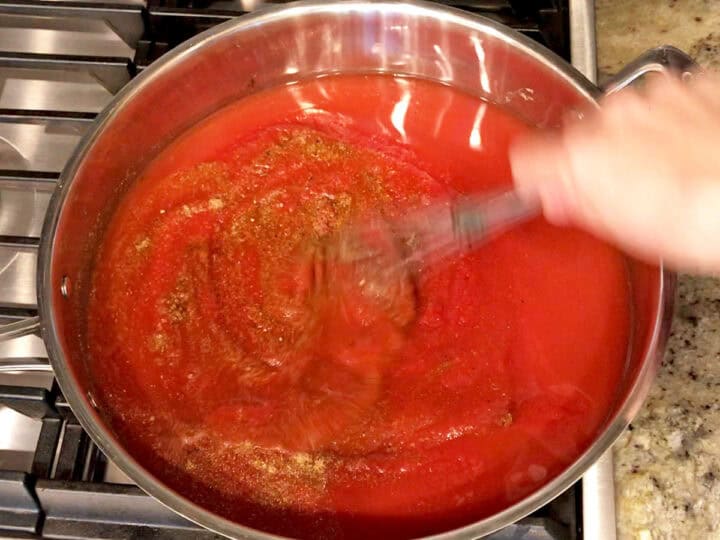 Whisking the soup ingredients in the saucepan.