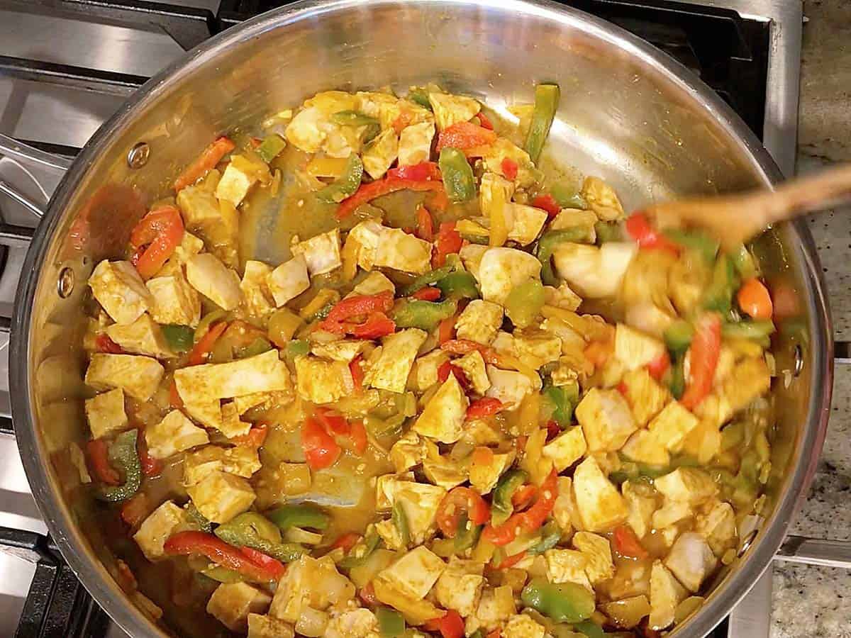 Mixing turkey into the curry.