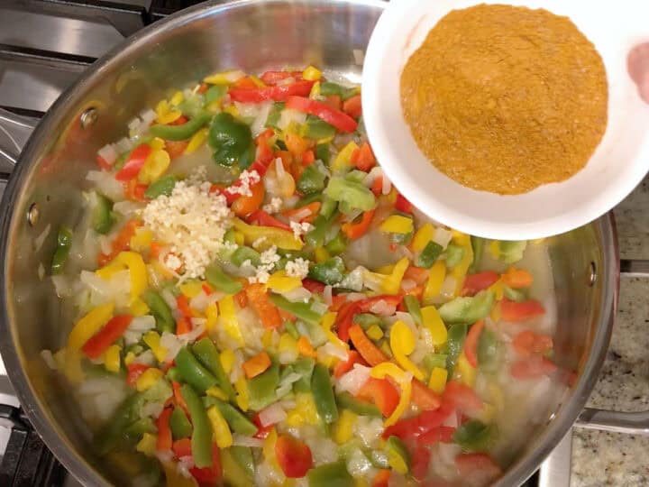 Adding spices to the saucepan.