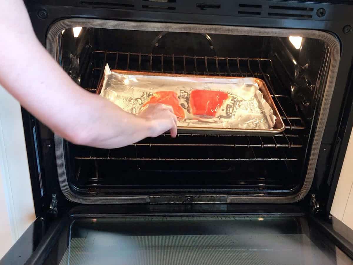 Placing the salmon in the oven.