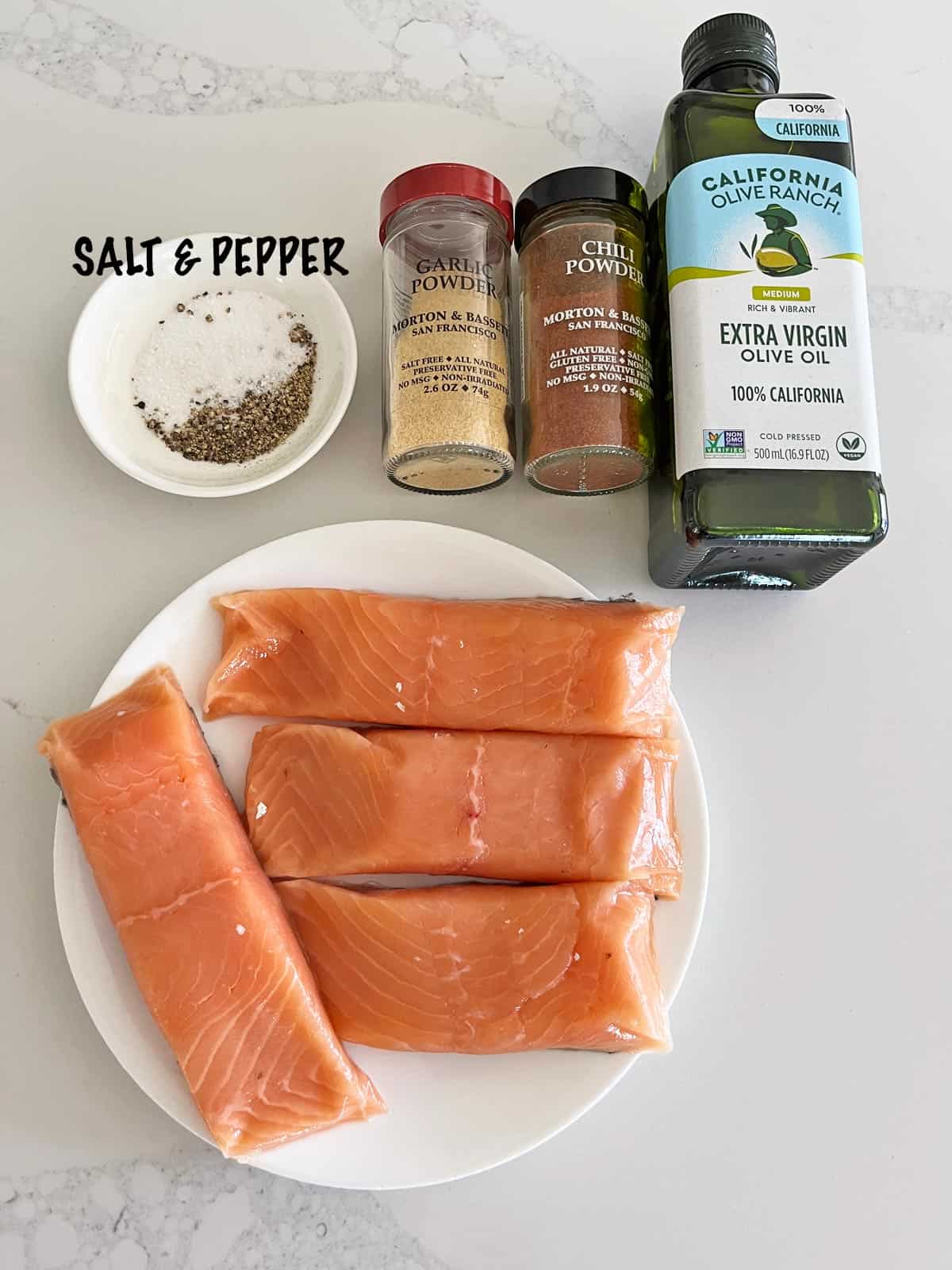 The ingredients needed to prepare broiled salmon.