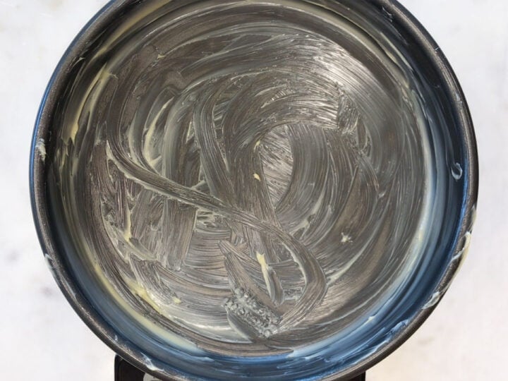 A buttered cake pan.