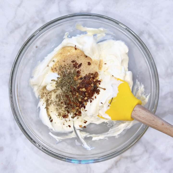 Mixing cream cheese and spices.