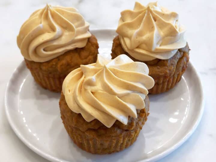 The cupcakes are served on a plate.