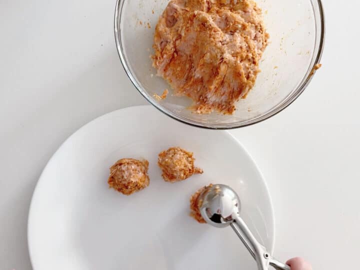 Dividing the mixture into portions with a scoop.